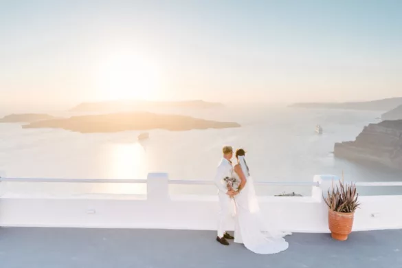 Bride and groom looking at the coastline in Santorini