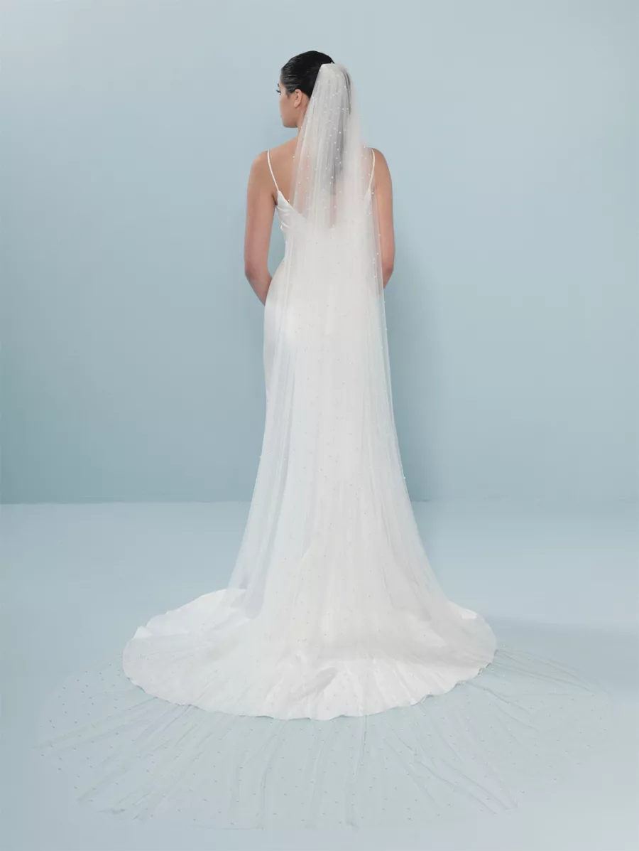 Model wearing a long veil with scattered pearl detailing