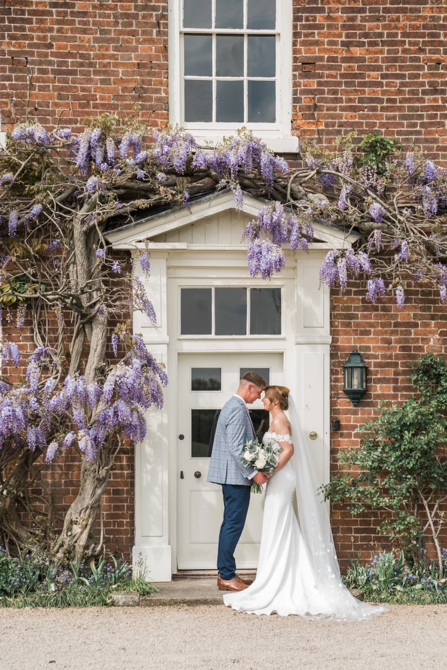 Bride and groom in front of country house