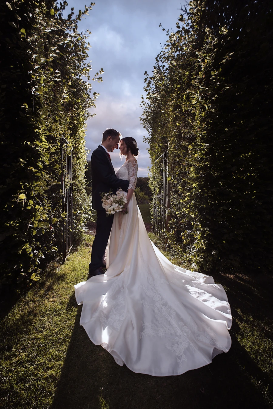 Bride and groom standing in a garden